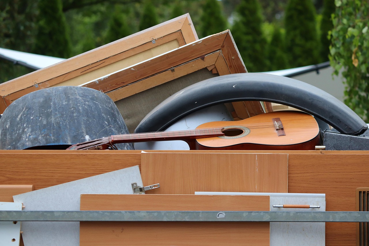 A trailer loaded with old cabinet panels, picture frames and a guitar
